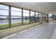 Enclosed sunroom with tile flooring and expansive views of the waterfront at 1009 Andover Cir, Sun City Center, FL 33573