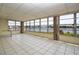 Bright sunroom with tile floors and expansive views of the waterfront at 1009 Andover Cir, Sun City Center, FL 33573