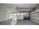 Spacious garage with room for parking and storage, also features a door to the exterior at 1009 Andover Cir, Sun City Center, FL 33573
