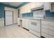 Open-concept kitchen featuring modern appliances and bright white cabinetry at 1009 Andover Cir, Sun City Center, FL 33573