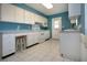 Well-lit kitchen featuring white cabinets, blue walls, and ample counter space at 1009 Andover Cir, Sun City Center, FL 33573