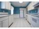 Spacious kitchen with white cabinetry, a window, and updated appliances at 1009 Andover Cir, Sun City Center, FL 33573