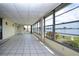 Spacious sunroom with many windows and a tile floor overlooking the lake at 1009 Andover Cir, Sun City Center, FL 33573