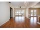Open living space with hardwood floors, a ceiling fan, and a view of the lanai and pool at 1009 Andover Cir, Sun City Center, FL 33573
