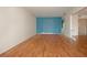 Empty living room with a blue wall and wood floors ready for new décor at 1009 Andover Cir, Sun City Center, FL 33573