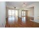 Open living room featuring wood floors, a chandelier, and access to the outdoor area at 1009 Andover Cir, Sun City Center, FL 33573