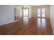 Bright living room features wood floors, bi-fold doors, and doors to backyard at 1009 Andover Cir, Sun City Center, FL 33573