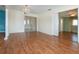 Bright living room with wood floors, chandelier, and view into other rooms at 1009 Andover Cir, Sun City Center, FL 33573