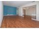 Bright living room featuring wood floors, and an open floor plan to the dining area at 1009 Andover Cir, Sun City Center, FL 33573