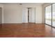 Spacious room with wood floors, bi-fold doors, and a glass-enclosed porch at 1009 Andover Cir, Sun City Center, FL 33573
