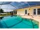 Sparkling screened pool with views of the backyard, waterfront and lawn at 1009 Andover Cir, Sun City Center, FL 33573