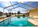 Beautiful screened-in pool featuring scenic waterfront views and lush landscaping at 1009 Andover Cir, Sun City Center, FL 33573
