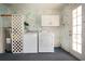 The utility room features a washer, dryer, water heater, and built in storage cabinets at 1009 Andover Cir, Sun City Center, FL 33573