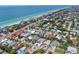 Stunning aerial view of a beach house with ocean views and lush tropical landscaping at 101 8Th St, Belleair Beach, FL 33786
