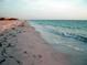 Scenic view of a sandy beach with gentle waves rolling onto the shore, perfect for relaxation at 101 8Th St, Belleair Beach, FL 33786