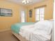 Bright bedroom with a bed, light yellow walls, shutters and art on the walls creating a peaceful retreat at 101 8Th St, Belleair Beach, FL 33786