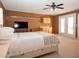 Cozy bedroom features a bed, TV, French doors, and ample natural light at 101 8Th St, Belleair Beach, FL 33786