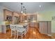 Well-lit kitchen boasts hardwood floors, stainless steel appliances, granite countertops, and ample cabinet space at 101 8Th St, Belleair Beach, FL 33786