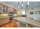 This kitchen features an island with wine cooler, granite countertops, stainless steel appliances, and hardwood flooring at 101 8Th St, Belleair Beach, FL 33786