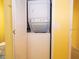 Laundry area featuring a stacked washer and dryer and a white louvered door at 101 8Th St, Belleair Beach, FL 33786