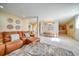 Open-concept living room with leather couch, glass coffee table, and views to the dining area at 101 8Th St, Belleair Beach, FL 33786