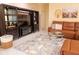 Cozy living room featuring a leather sectional sofa, stylish shelving unit, and a chic glass coffee table at 101 8Th St, Belleair Beach, FL 33786