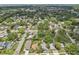Expansive aerial view showing the neighborhood, highlighting residential streets and lush green spaces at 1015 13Th Nw Ave, Largo, FL 33770