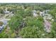 An aerial shot of a home surrounded by mature trees, showcasing the peaceful neighborhood and backyard at 1015 13Th Nw Ave, Largo, FL 33770