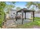 Backyard featuring a gazebo, storage shed, and staircase to the back door at 1015 13Th Nw Ave, Largo, FL 33770