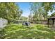 Expansive backyard featuring lush lawn, seating and mature trees providing plenty of shade at 1015 13Th Nw Ave, Largo, FL 33770