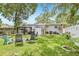 Backyard featuring a gazebo, storage shed, and staircase to the back door with patio furniture at 1015 13Th Nw Ave, Largo, FL 33770