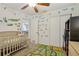 Fun Bedroom with reptile themed wall decals, crib, and area rug at 1015 13Th Nw Ave, Largo, FL 33770