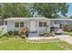 Charming single-story home with well-maintained lawn and covered parking at 1015 13Th Nw Ave, Largo, FL 33770