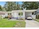 Charming single-story home with a well-manicured lawn, carport and inviting front entrance at 1015 13Th Nw Ave, Largo, FL 33770