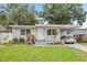 Charming single-story home with a well-manicured lawn, carport and inviting front entrance at 1015 13Th Nw Ave, Largo, FL 33770
