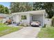 Charming single-story home with a well-manicured lawn, carport and inviting front entrance at 1015 13Th Nw Ave, Largo, FL 33770