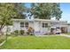 Charming single-story home with a well-manicured lawn, carport and inviting front entrance at 1015 13Th Nw Ave, Largo, FL 33770