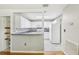 Bright kitchen featuring white cabinets, grey countertops, and a stylish tile backsplash at 1015 13Th Nw Ave, Largo, FL 33770