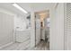 Open laundry room with washer, dryer, and entry door to a bathroom and second exterior door at 1015 13Th Nw Ave, Largo, FL 33770