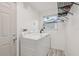 Bright laundry room with updated washer and dryer and a sunny window at 1015 13Th Nw Ave, Largo, FL 33770