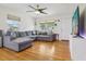 Bright living room featuring hardwood floors, recessed lighting, ceiling fan and large sectional at 1015 13Th Nw Ave, Largo, FL 33770