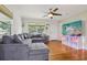 Bright living room featuring hardwood floors, recessed lighting, ceiling fan and large sectional at 1015 13Th Nw Ave, Largo, FL 33770