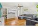Bright living room featuring hardwood floors, recessed lighting, ceiling fan and large sectional at 1015 13Th Nw Ave, Largo, FL 33770