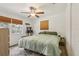 Main bedroom with a queen bed, ceiling fan, and natural light from two windows at 1015 13Th Nw Ave, Largo, FL 33770