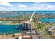 Expansive aerial view of a waterfront condominium with boat docks, offering scenic water access at 10355 Paradise Blvd # 1003, Treasure Island, FL 33706