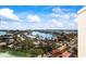 Breathtaking aerial view of waterfront property, city skyline, and lush landscape at 10355 Paradise Blvd # 1003, Treasure Island, FL 33706