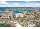 Aerial view of condo complex surrounded by beautiful water views and tropical landscaping at 10355 Paradise Blvd # 1003, Treasure Island, FL 33706
