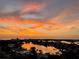 Scenic sunset view of waterfront homes and a calm canal reflecting colorful sky at 10355 Paradise Blvd # 1003, Treasure Island, FL 33706