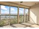 Relaxing screened in balcony with seating, coffee table, ceiling fan and expansive water views at 10355 Paradise Blvd # 1003, Treasure Island, FL 33706