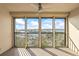 Relaxing screened in balcony with seating, coffee table, ceiling fan and expansive water views at 10355 Paradise Blvd # 1003, Treasure Island, FL 33706